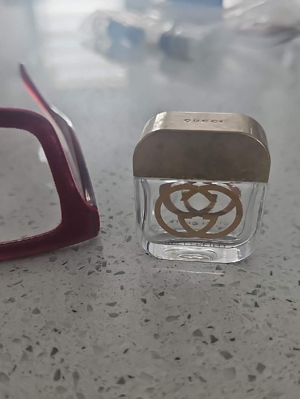 Gucci clear mini bottle with gold logo and cap
